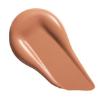Swatch of Revolution Conceal & Define Soft Matte Tube Foundation in a warm shade, showcasing its smooth texture.