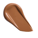 Swatch of Revolution Conceal & Define Soft Matte Tube Foundation in a rich, medium brown shade.