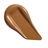 Swatch of Revolution Conceal & Define Soft Matte Tube Foundation in a rich brown shade for flawless coverage.