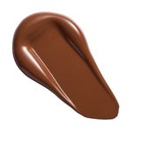 Swatch of Revolution Conceal & Define Soft Matte Tube Foundation in a rich brown shade, showcasing its creamy texture.