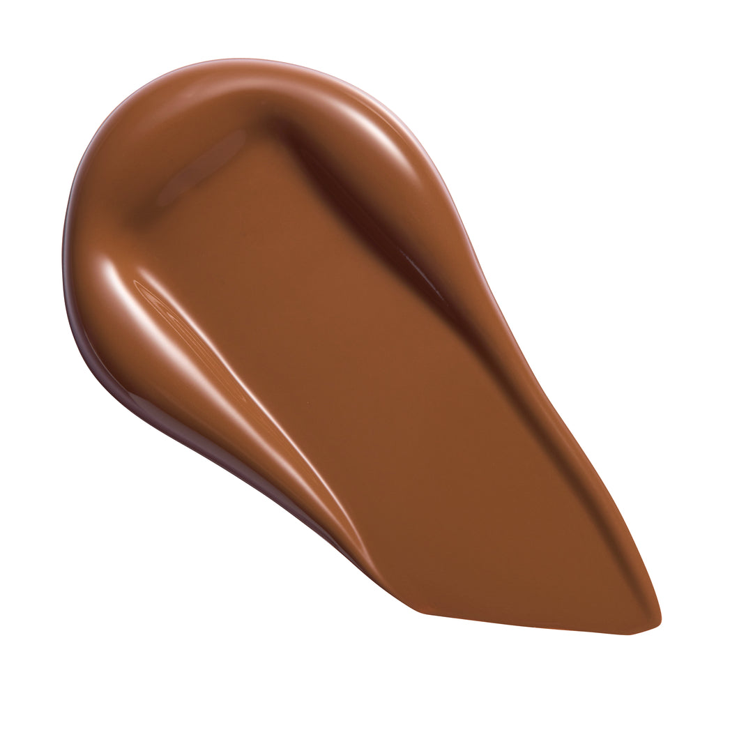 Revolution Conceal & Define Soft Matte Tube Foundation swatch in rich brown shade, showcasing full-coverage matte finish