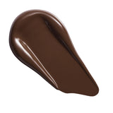 Revolution Conceal & Define Soft Matte Tube Foundation swatch in rich brown shade, showcasing its creamy texture.