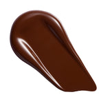 Revolution Conceal & Define Soft Matte Tube Foundation swatch in deep brown shade, showcasing the smooth texture and full coverage.
