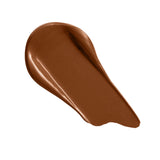 Revolution Conceal and Define Full Coverage Concealer swatch in rich brown shade, showcasing creamy texture and blendability.