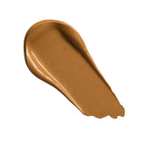 Swatch of Revolution Conceal and Define Full Coverage Concealer in a warm, tan shade on a white background.