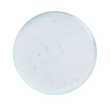 Revolution Dewy Fix PDRN + HA Hydrating Capsule Setting Spray in a round clear dish.