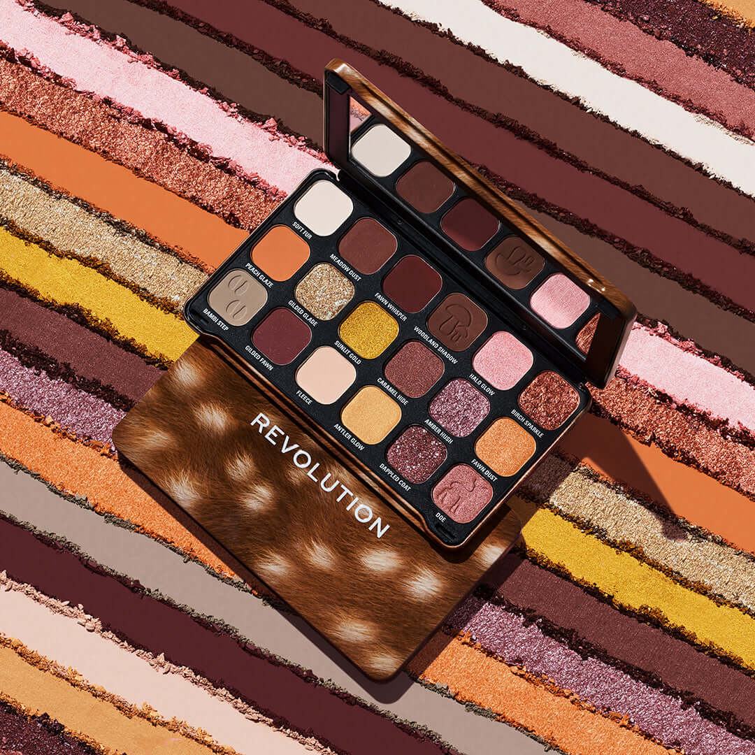 Revolution Forever Flawless Doe Eyes Eyeshadow Palette displayed on colorful textured background.