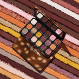 Revolution Forever Flawless Doe Eyes Eyeshadow Palette displayed on colorful textured background.