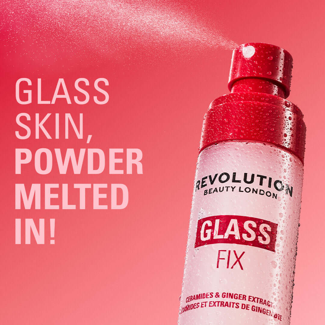 Revolution Glass Fix Powder Melting Setting Spray with a dewy mist on a pink background for radiant skin.