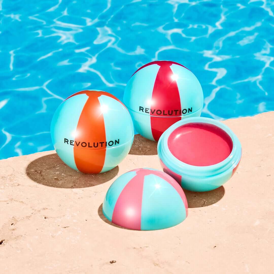 Revolution Inflatable Glow Lip & Cheek Tint in playful jelly balls by the poolside, showcasing vibrant colors and textures.