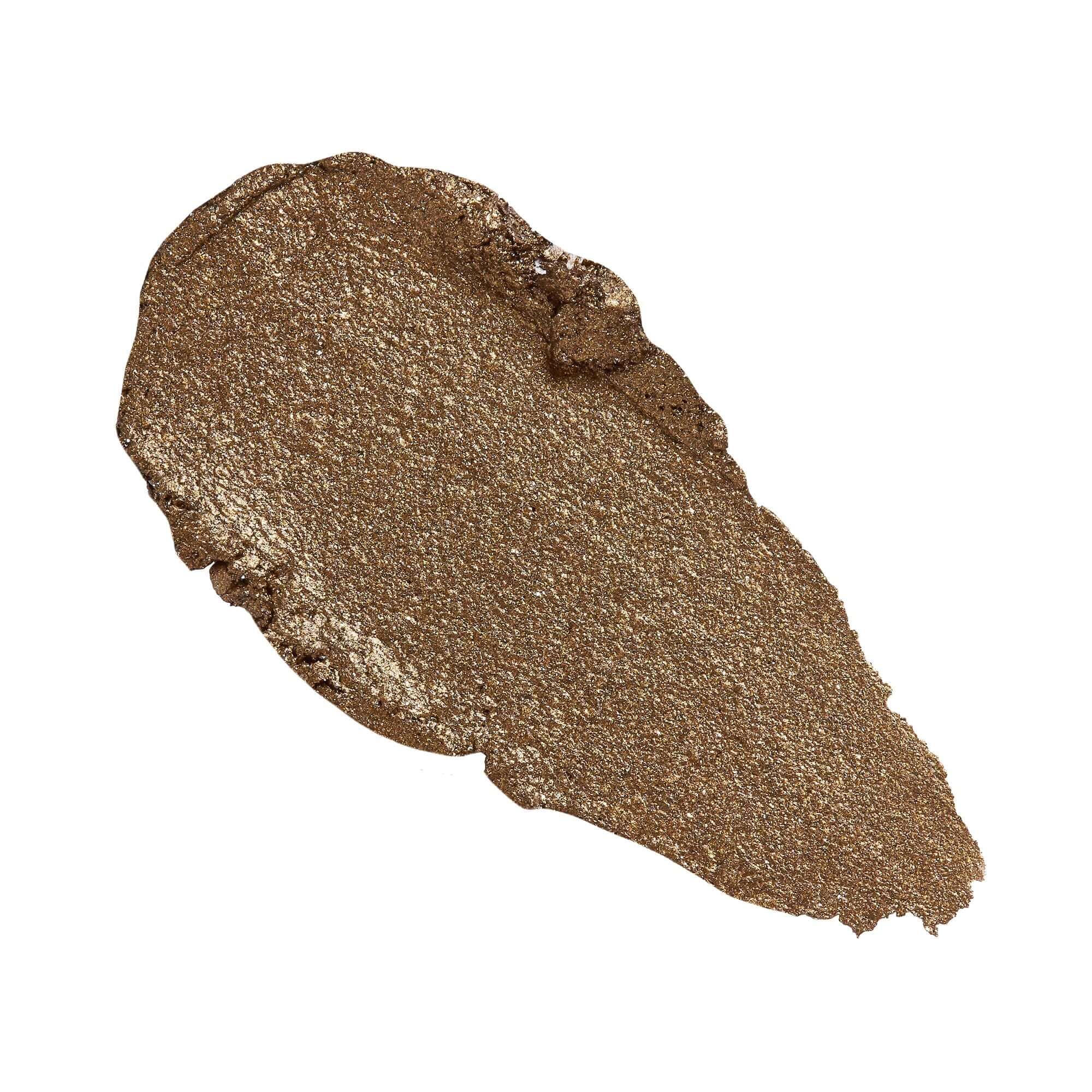 Revolution Just Chillin' Cooling Shadow Stick swatch in a shimmery bronze shade showcasing its lightweight texture