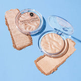 Revolution Reloaded Highlighter in clear packaging with powder swatches on a blue background.