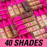 Variety of Revolution Superfix Blur Longwear Foundation bottles in 40 shades, featuring pink caps.