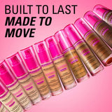 Revolution Superfix Blur Longwear Foundation bottles showcasing diverse shades against a pink background.