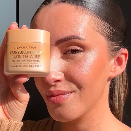 woman holding Revolution's Translucent Glow Baking Powder
